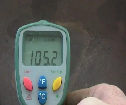 An infrared thermometer reading the hotplate at 105.2°C