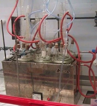 The glassware corrosion test rig: flasks of coolant in a heated bath, with condensers and air lines