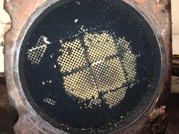 A diesel particulate filter's face mostly blocked with black carbon