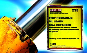 A 1 litre can of Liquid Intelligence 235 in front of a hydraulic ram. The label reads: stops hydraulic oil leaks by swelling and softening dried and hardened seals and gaskets; treats up to 20 litres of hydraulic oil.