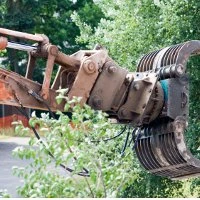 A grab attachment on the end of an excavator arm