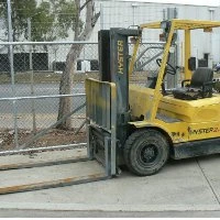 A forklift parked outside a factory