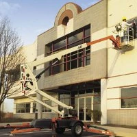 A boom lift raised beside a building