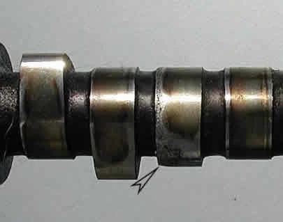 Close-up of a camshaft lobe worn away by a flat tappet