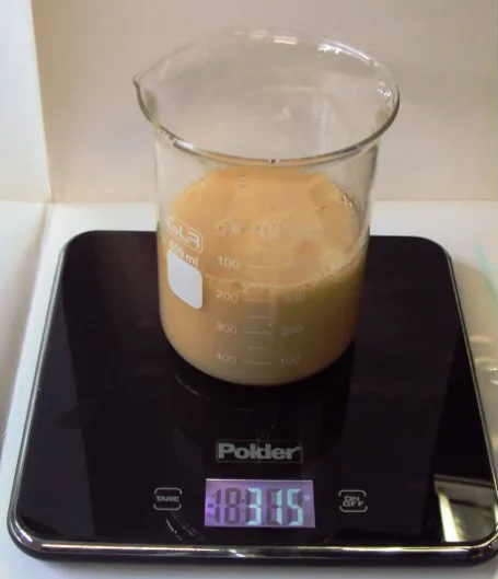 The beaker's contents turned an even, milky tan colour