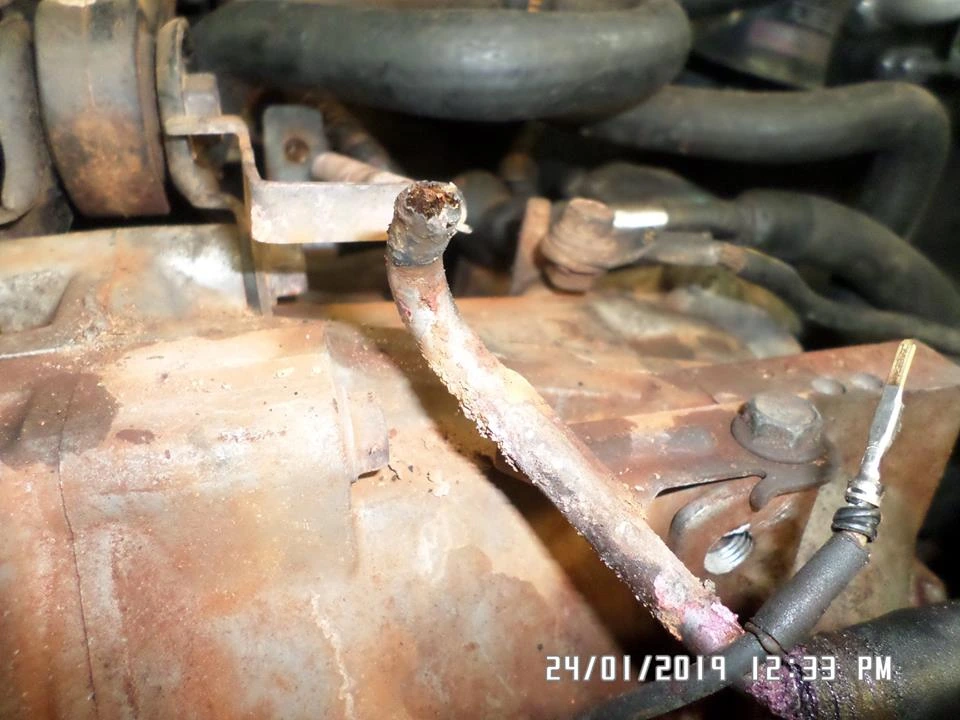 A coolant pipe whose end has corroded away where the hose seals