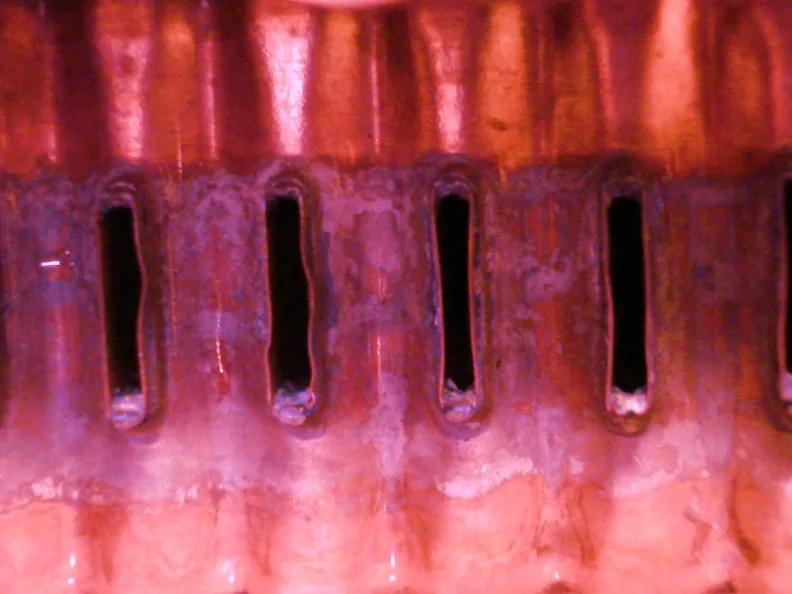The same radiator after Liquid Intelligence 239: the scale deposits dissolved and the tube openings clear, restoring full coolant flow