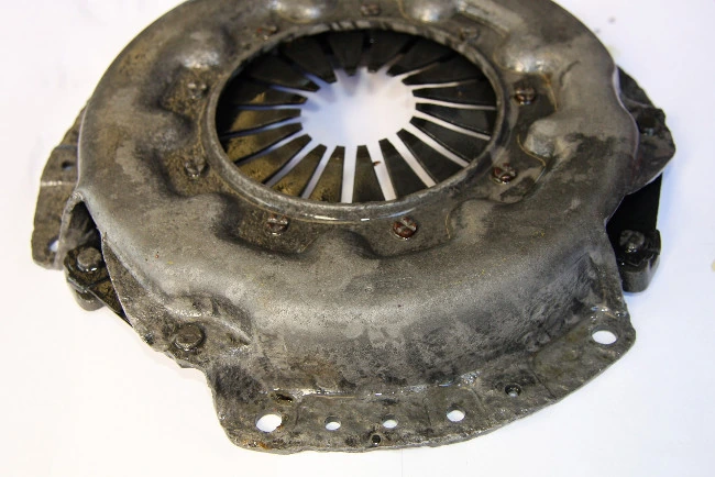 The same clutch pressure plate after 240: clean grey metal with the rust gone
