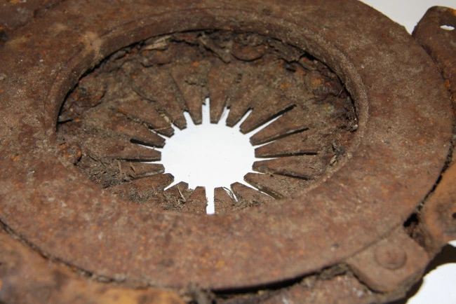 The face of a clutch pressure plate coated in deep rust