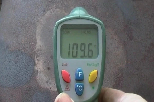 A thermometer reading the hotplate at 109.6°C