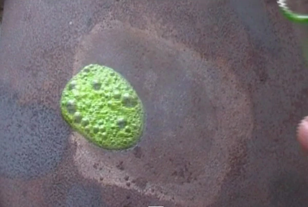 The green coolant boiling on the hotplate