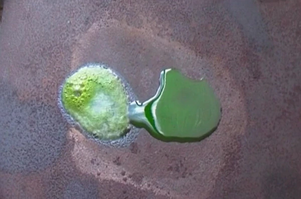 The green coolant boiling beside a pool of Liquid Intelligence 500 that isn't