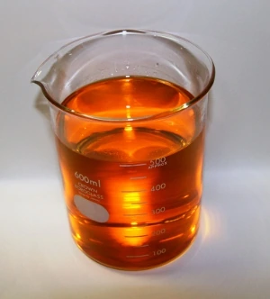 A beaker of Liquid Intelligence 318, a clear golden liquid