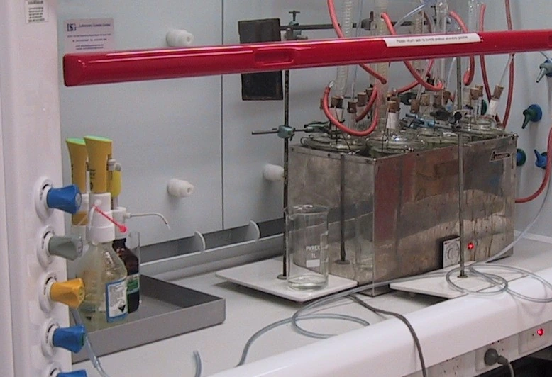 The ASTM D1384 glassware corrosion test running in a laboratory: flasks of coolant in a heated bath