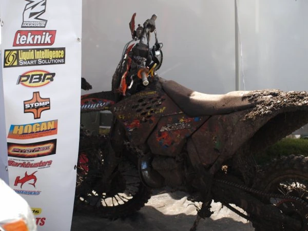 The team bike in front of the sponsors’ board